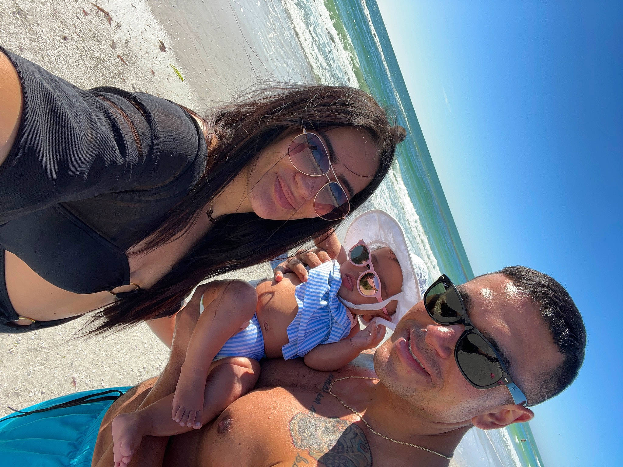 Angelica is registered to the contest to win money with this photo: blue, cool, eyewear, facial_expression, gesture, glasses, goggles, happy, hat, human, interaction, joy, leisure, people_on_beach, person, shorts, sky, smile, sunglasses, travel