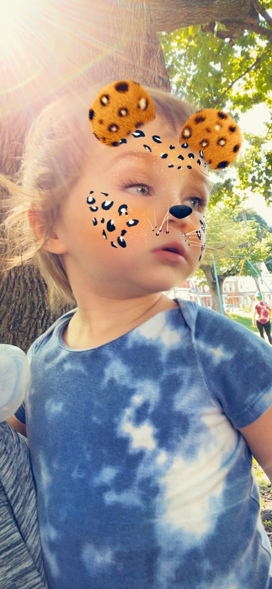 Leviathan is registered to the contest to win money with this photo: child, electric_blue, eyelash, eyewear, fashion_accessory, fun, grass, happy, headpiece, landscape, pattern, person, personal_protective_equipment, portrait_photography, sports_gear, t_shirt, toddler, tree, white