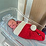 newborn, baby, hospital, bassinet, crochet, red, white, blanket, infant, sleeping, hand, face, person, hospital_room, bed, cute, cozy, wrapped, lying_down, indoors