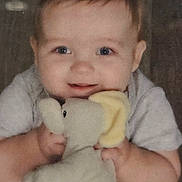 Ethan joined the competition — help win amazing prizes! baby, blanket, bunny, child, close_up, clothing, cozy, curious, eyes, face, hands, hugging, indoors, infant, photograph, portrait, sitting, soft_lighting, stuffed_animal, toy