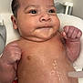 baby, infant, wet_hair, mohawk, bath, water, fists, chubby_cheeks, skin, face, seat, expression, cute, child, newborn, indoors, portrait, head, torso, relaxing