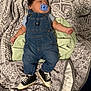 Auriel is registered to the contest to win money with this photo: baby, sleeping, pacifier, denim_overalls, sneakers, blanket, towel, patterned, cute, infant, clothing, footwear, bed, resting, indoor, soft, person, child, head, hair