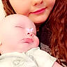 Randy is registered to the contest to win money with this photo: baby, child, person, sleeping, holding, selfie, portrait, face, filter, butterfly, nose, cute, young_person, long_hair, indoors, casual_clothing, smile, tender_moment, closeup, soft_light