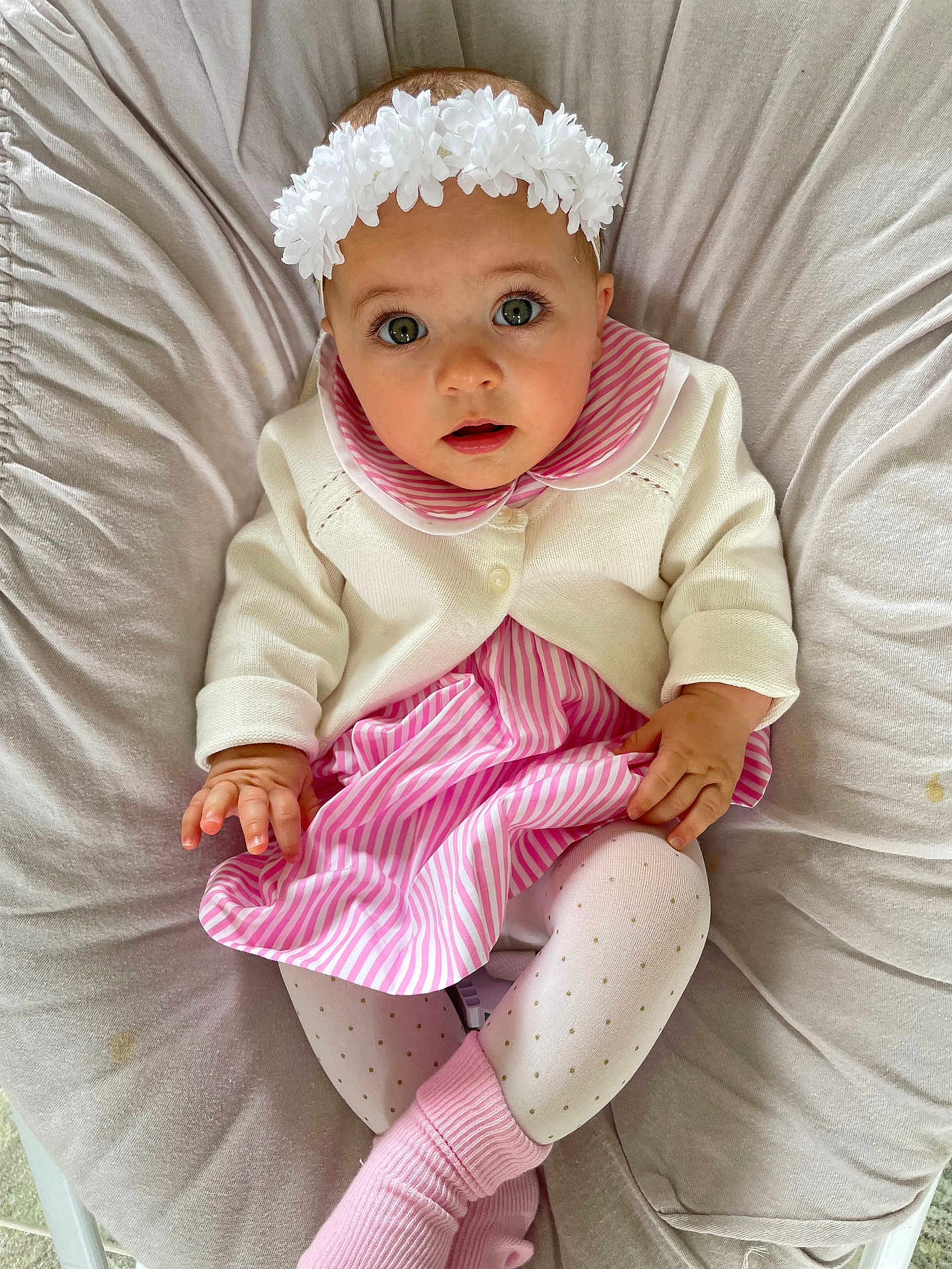 Juliette a rejoint le concours — aidez-le/la à gagner de superbes lots ! baby, child, infant, dress, cardigan, headband, flower, pink, white, striped, tights, socks, cushion, seated, indoors, soft_lighting, cute, portrait, looking_up, hands