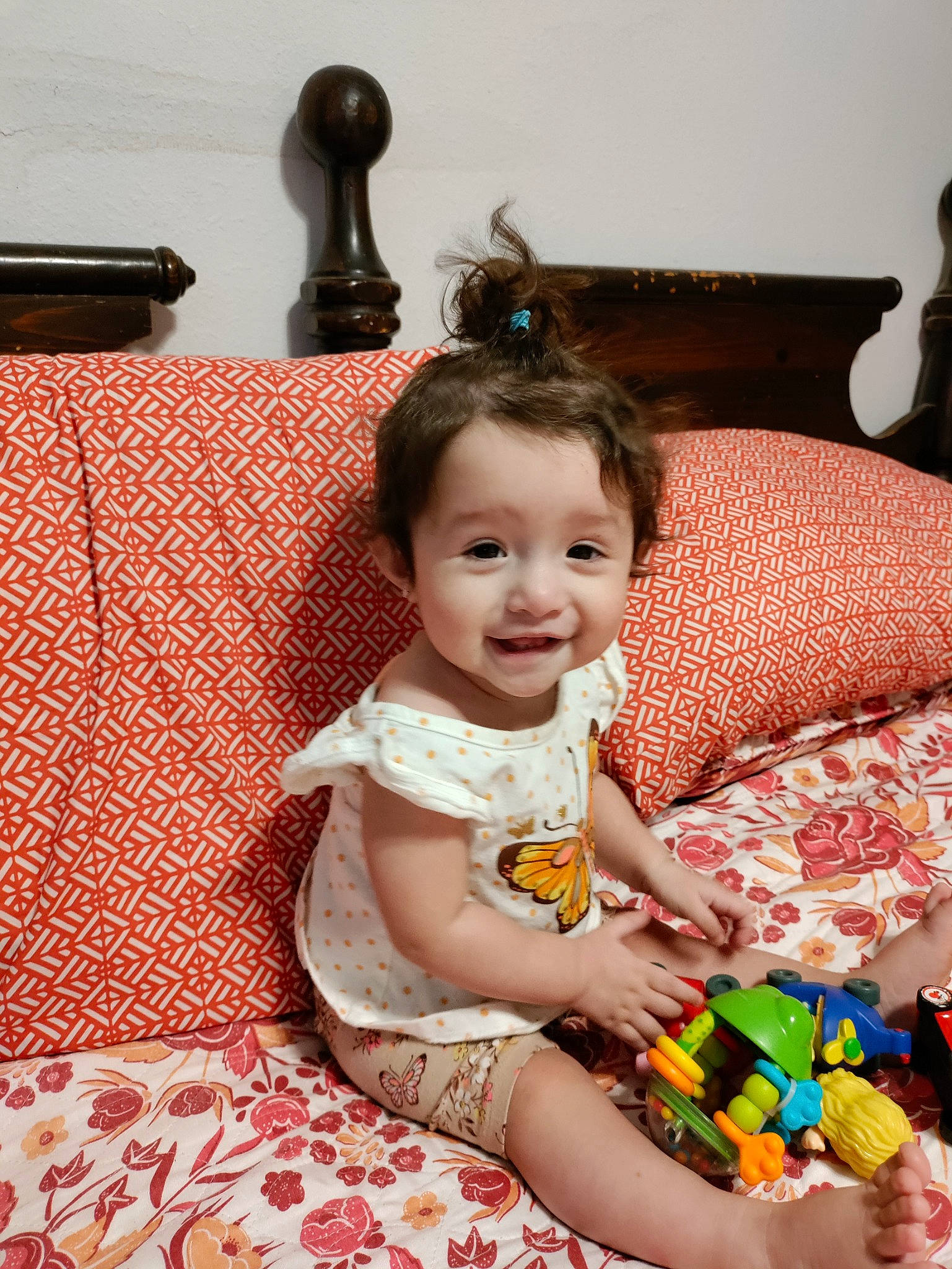 Claudia is registered to the contest to win money with this photo: baby, baby_toddler_clothing, child, comfort, couch, dress, event, fun, hairstyle, happy, joy, living_room, pattern, people, person, room, sitting, skin, smile, toddler