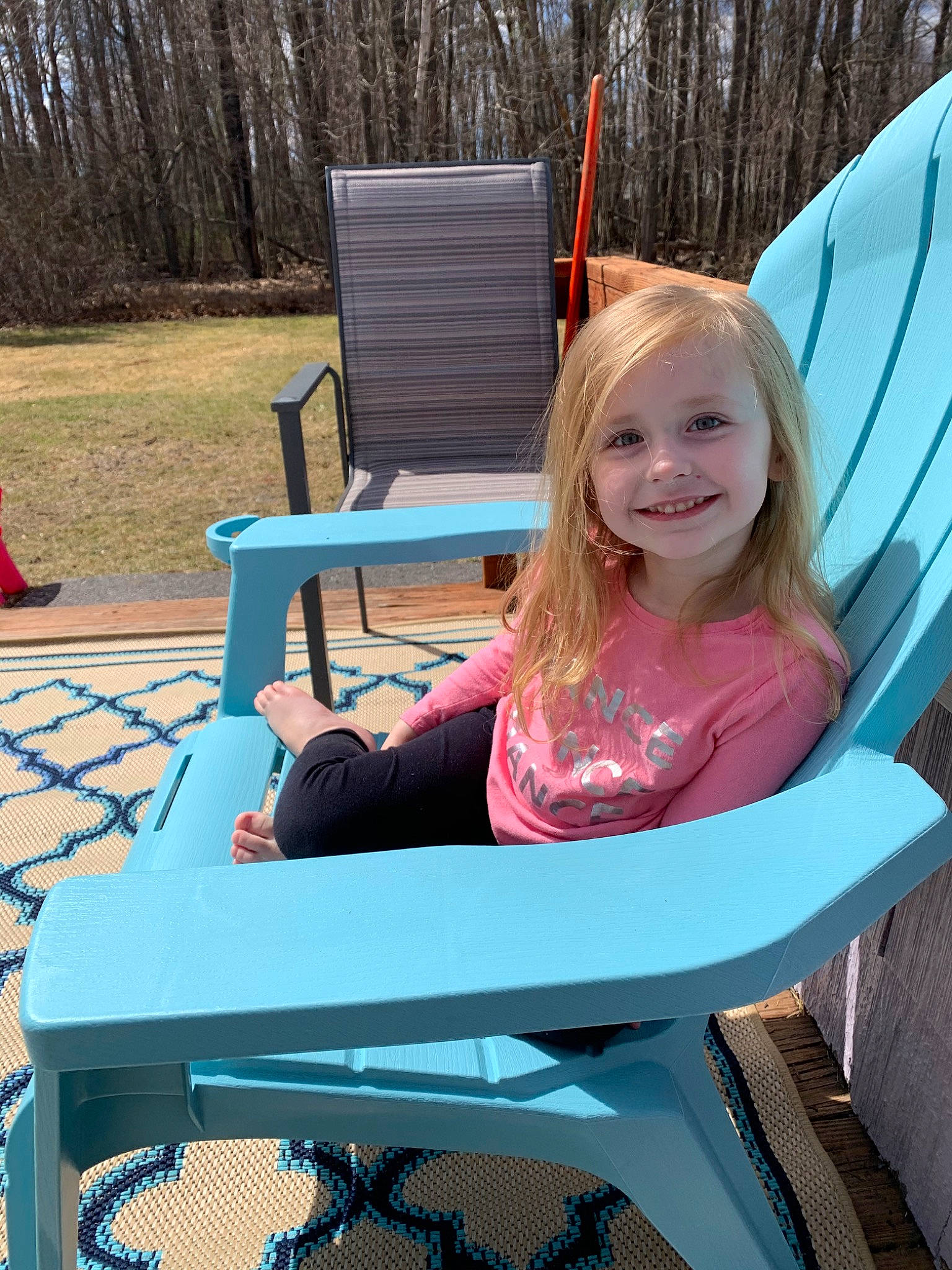 Finley is registered to the contest to win money with this photo: backyard, child, fawn, furniture, joy, leisure, outdoor_furniture, person, plant, play, sitting, summer, table, toddler, tree, vacation