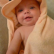 Olivia is registered to the contest to win money with this photo: baby, towel, hood, smile, face, child, cute, skin, eyes, arm, soft, peach, closeup, portrait, indoors, happy, infant, wrapped, cozy, bath