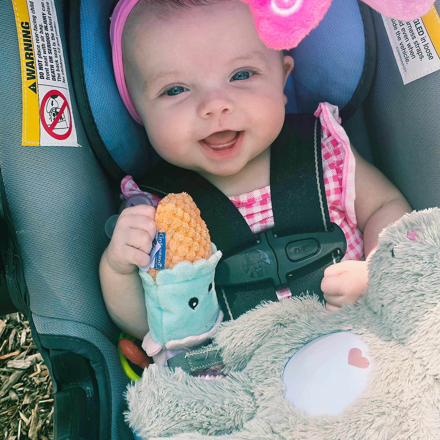 Olivia joined the competition — help win amazing prizes! baby, infant, car_seat, smiling, headband, flower, plush_toy, teether, pink_clothing, straps, child, cute, happy, face, person, seat, safety, outdoor, closeup, holding