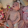 Olivia is registered to the contest to win money with this photo: baby, blanket, child, colorful, cozy, curious, cute, diaper, flower, headband, indoors, infant, lying_down, pink, playful, plush_toy, skin, small, soft, toy