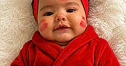 Sophia joined the competition — help win amazing prizes! adorable, baby, child, closeup, cozy, cute, face, fluffy_blanket, happy, headwear, indoors, infant, lipstick_marks, portrait, red_bow, red_headband, red_robe, smiling, soft_texture, young_child