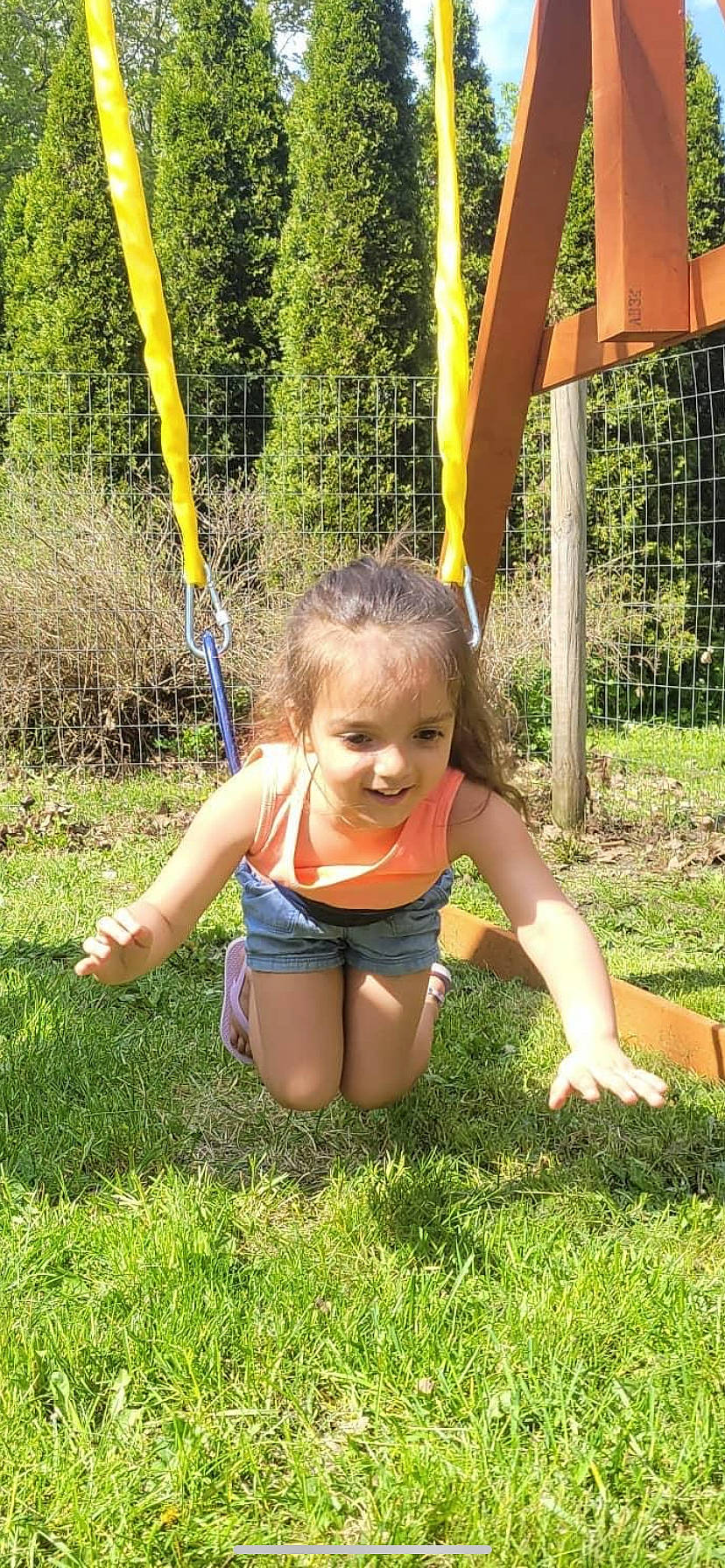 Azariyah joined the competition — help win amazing prizes! barefoot, entertainment, fun, grass, green, happy, joy, leaf, leisure, people_in_nature, person, plant, playground, recreation, shorts, smile, summer, swimwear, swing, thigh