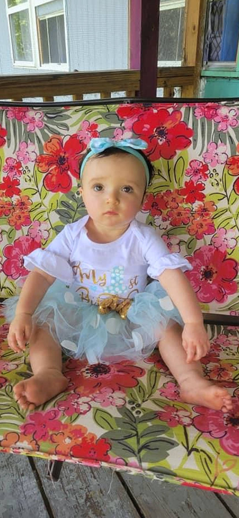 Leilanni is registered to the contest to win money with this photo: baby, baby_toddler_clothing, botany, cheek, child, flower, grass, happy, leaf, magenta, pattern, people_in_nature, person, petal, pink, plant, sitting, skin, sleeve, textile