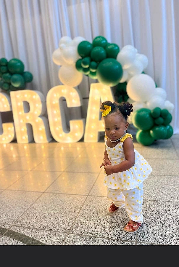 Legacy is registered to the contest to win money with this photo: baby, balloon, child, clothing, dress, event, flash_photography, fun, happy, leisure, party, party_supply, person, play, recreation, sandal, sweetness, toddler