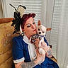 woman, dog, chihuahua, tattoos, vintage_chair, blue_dress, red_hair, makeup, face, pet, holding, indoor, curtains, window_blind, patterned_clothing, small_dog, seated, love, portrait, fashion