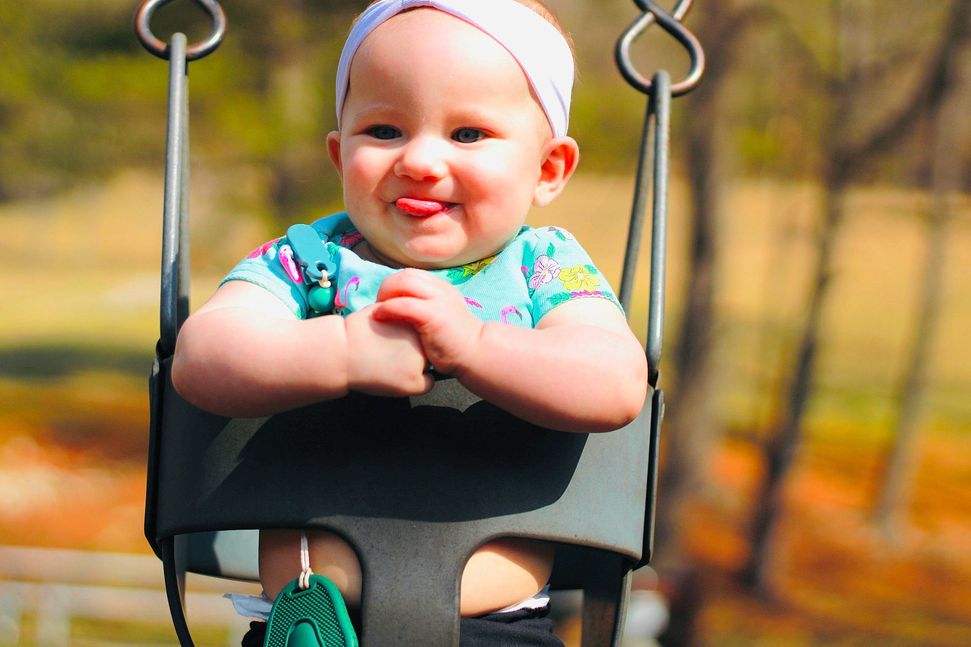 Kyla is registered to the contest to win money with this photo: baby, baby_toddler_clothing, cheek, child, chin, city, eye, facial_expression, fun, grass, green, happy, joy, leisure, person, playground, public_space, recreation, skin, smile