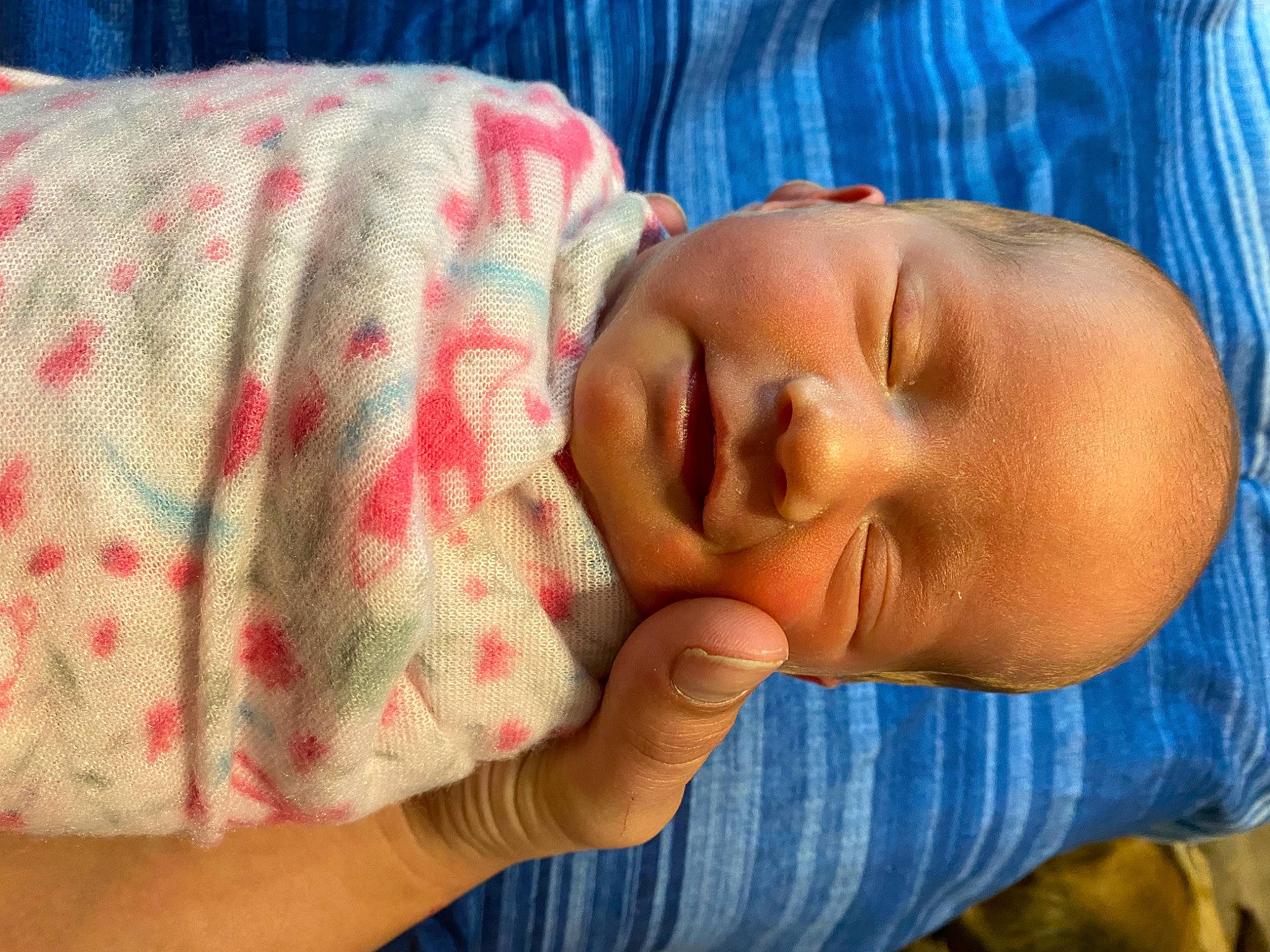 Kyla is registered to the contest to win money with this photo: baby, baby_toddler_clothing, cheek, child, comfort, ear, eye, finger, hand, happy, head, human_body, iris, lip, mouth, nose, person, skin, sleeve, thumb