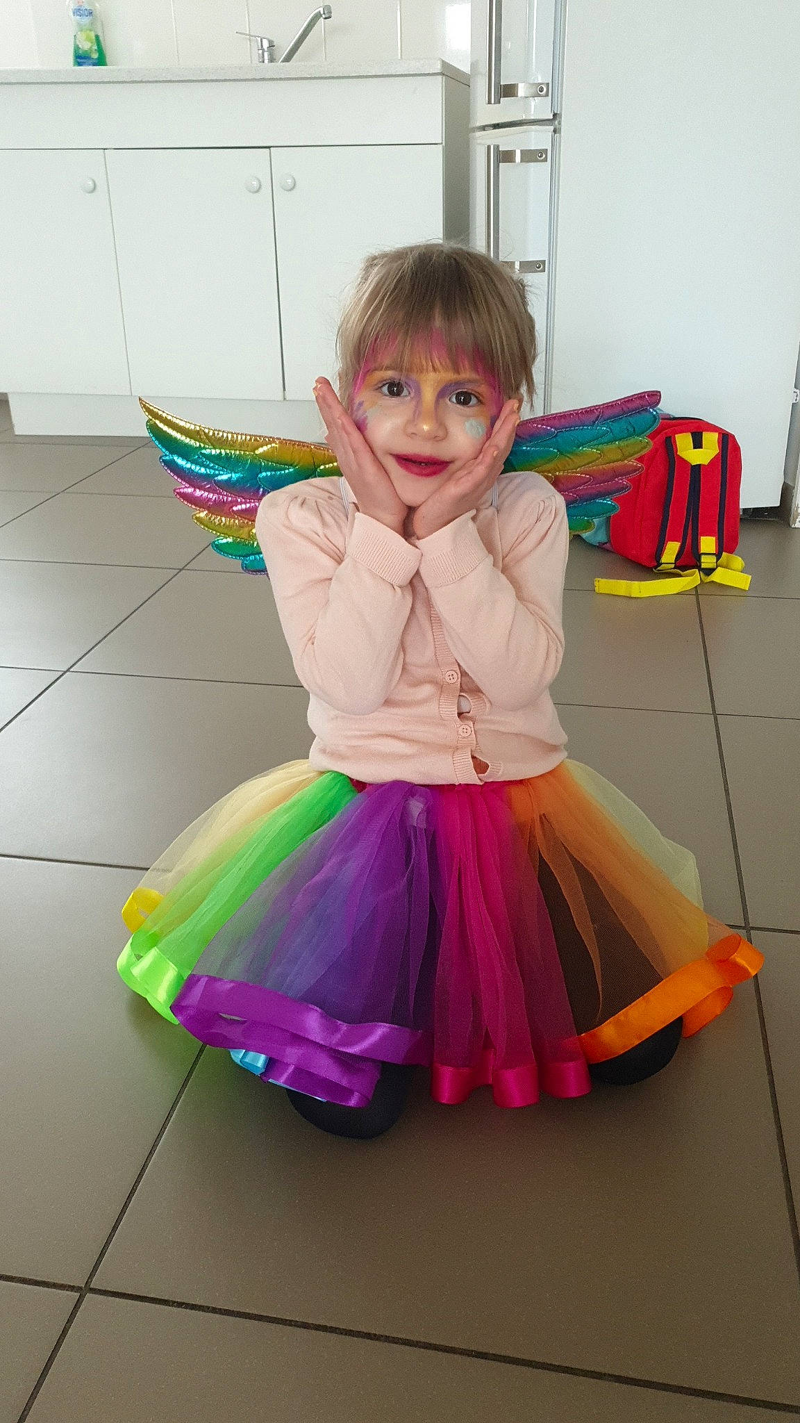 Lyna participe au concours pour gagner de l'argent avec cette photo : baby_toddler_clothing, child, costume, event, flooring, fun, happy, magenta, pattern, person, pink, play, purple, ruffle, sitting, smile, sock, toddler