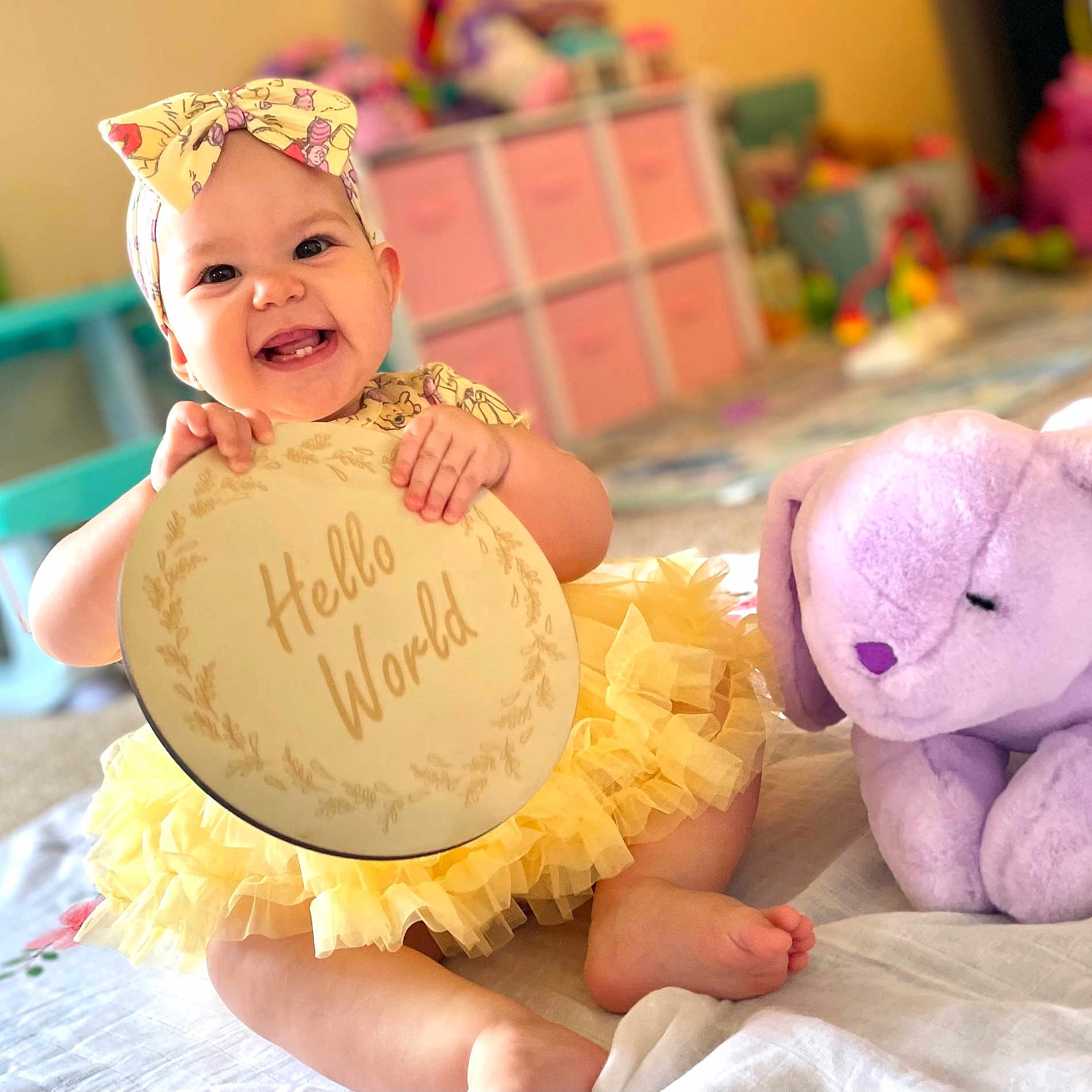 Scarlett joined the competition — help win amazing prizes! baby, bed, bedroom, clothing, costume, dress, face, furniture, happy, head, homedecor, indoors, laughing, person, photography, portrait, sitting, smile, teddybear, toy