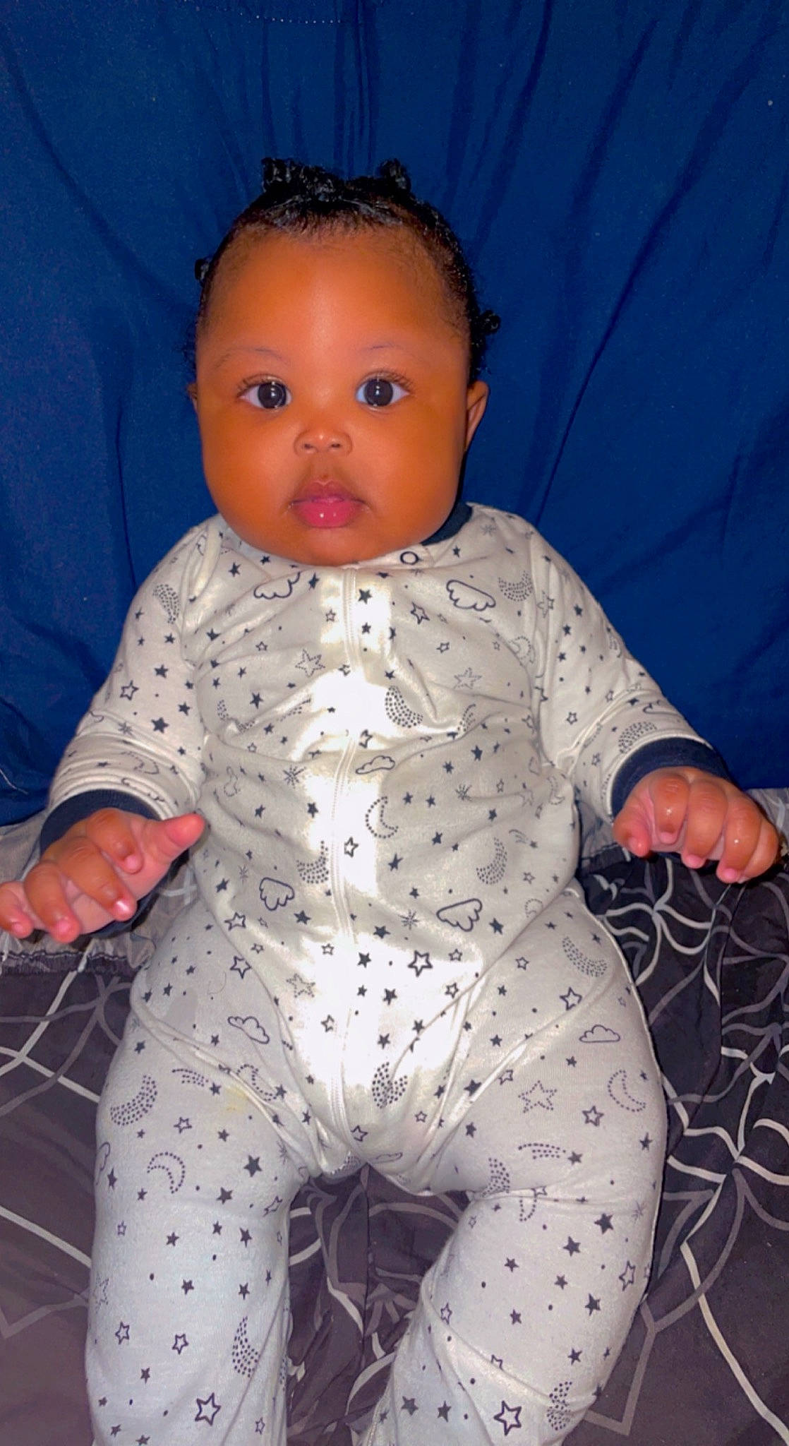 Jonah is registered to the contest to win money with this photo: baby, baby_toddler_clothing, blue, carmine, cheek, chest, child, comfort, electric_blue, leg, linens, nail, nose, pattern, person, sitting, skin, sleeve, thigh, thumb