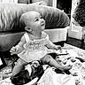 baby, black_and_white, blanket, child, clothing, couch, cute, decor, furniture, happy, home, indoors, infant, playful, plush_toy, portrait, sign, sitting, smile, young