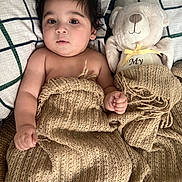Iacov joined the competition — help win amazing prizes! baby, blanket, teddy_bear, pillow, bed, knitted, child, cute, soft, sleepy, plush_toy, face, expression, curly_hair, indoors, comfort, rest, cozy, snug, warm