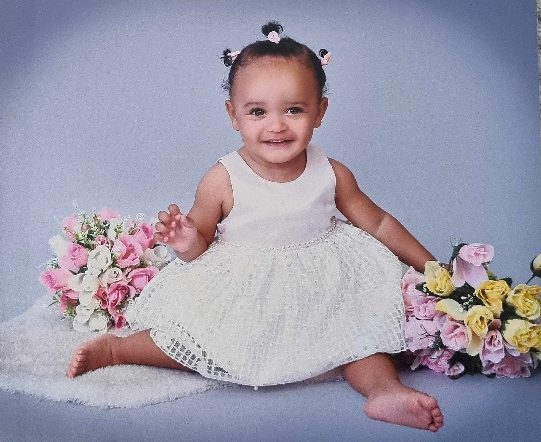 Serenity joined the competition — help win amazing prizes! toddler, child, smiling, dress, white_dress, flowers, bouquet, pink_flowers, yellow_flowers, sitting, happy, cute, hair_buns, studio, portrait, baby, soft_rug, innocent, pretty, celebration