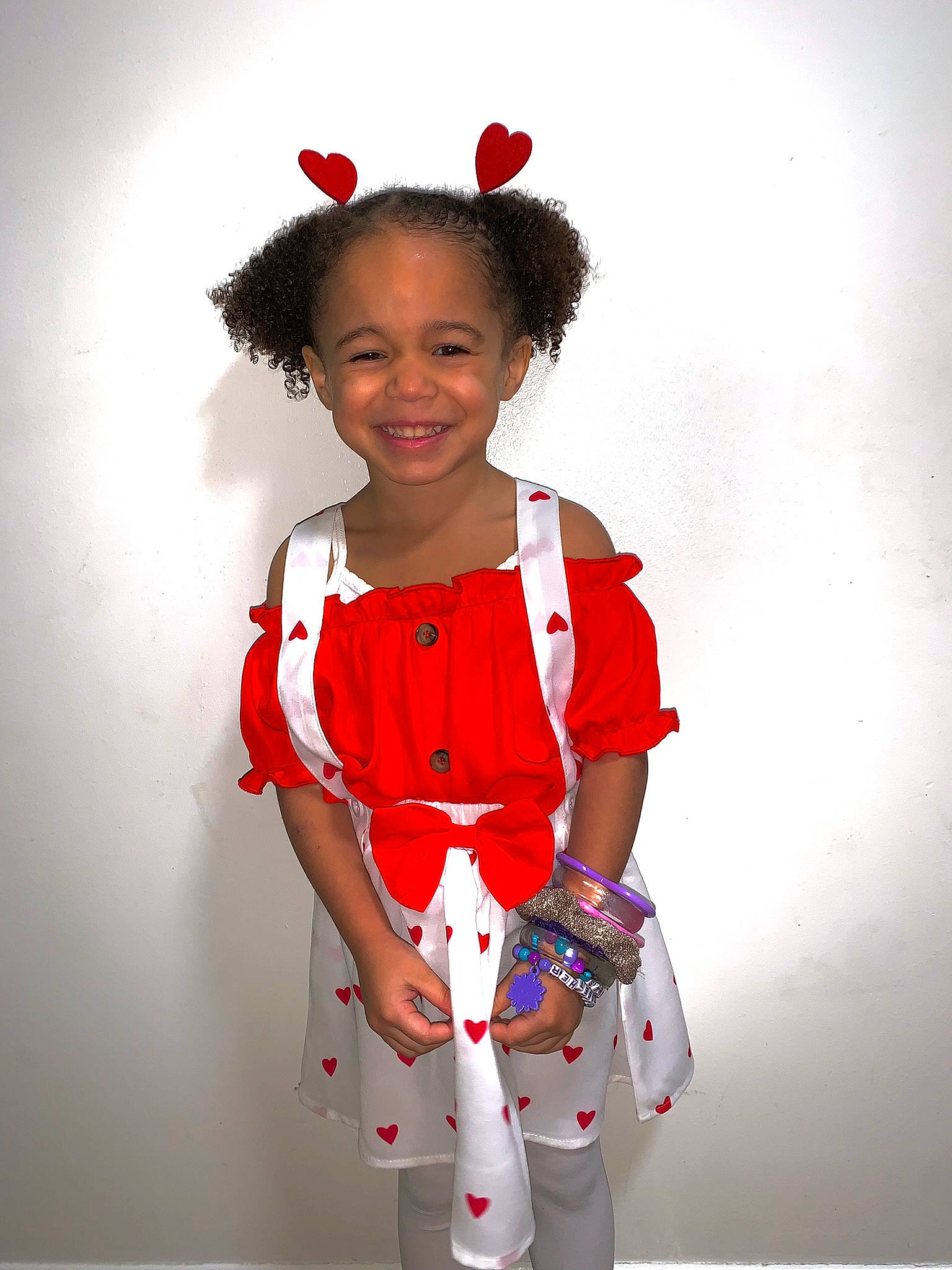 Kara is registered to the contest to win money with this photo: baby_toddler_clothing, carmine, child, day_dress, electric_blue, event, fashion_accessory, fashion_design, fun, gesture, happy, joy, magenta, one_piece_garment, pattern, person, pink, sleeve, smile, standing