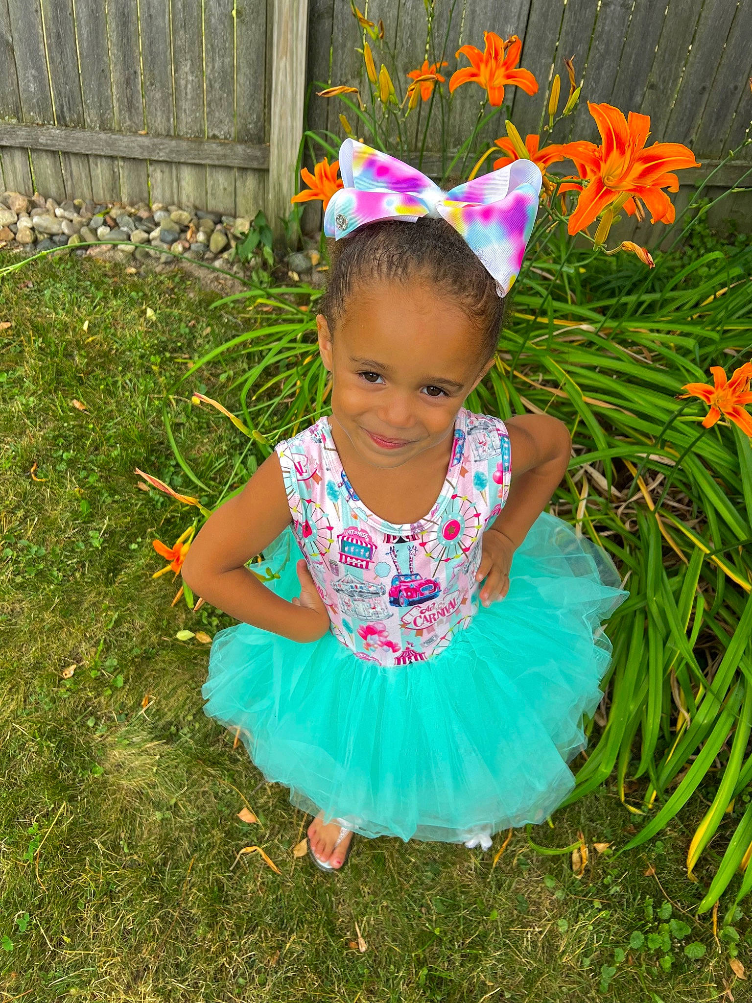 Kara is registered to the contest to win money with this photo: baby_toddler_clothing, child, electric_blue, facial_expression, flower, fun, grass, grass_family, grassland, happy, joy, magenta, meadow, nature, people_in_nature, person, petal, pink, plant, smile