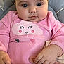 baby, child, infant, pink_clothing, cloud_design, seat, cushion, hand, face, eyes, cheeks, curious, cute, indoors, portrait, sitting, clothing, smile, soft_toys, strap