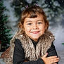 background, black_sweater, blur, child, christmas_tree, cozy, cute, fashion, fur_vest, girl, happy, holiday, indoor, portrait, posing, smiling, snow, soft_surface, winter, young