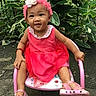 toddler, child, pink_dress, headband, flower, sandals, chair, outdoor, greenery, smiling, happy, cute, nature, person, portrait, baby, seat, plant, young_child, playful