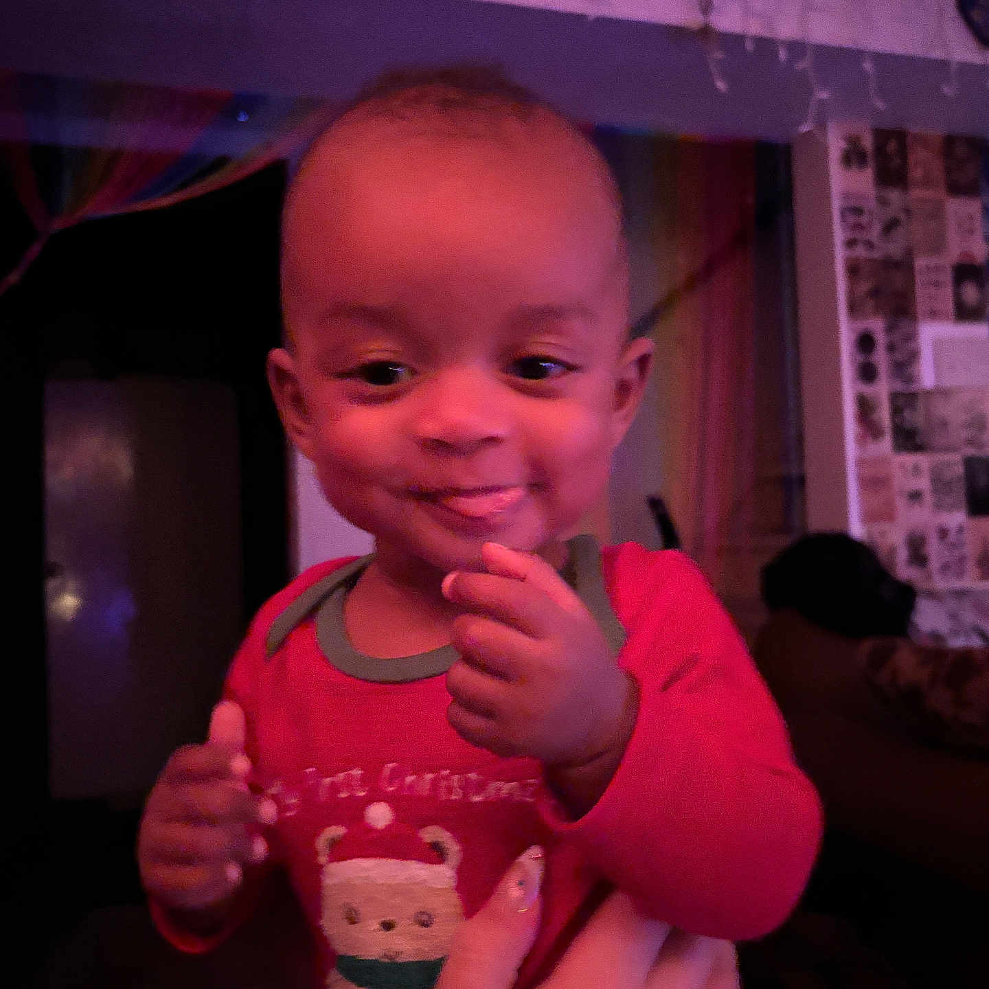 Xavier joined the competition — help win amazing prizes! baby, background, child, cozy, curtains, cute, face, festive, hand, happy, holding, home, indoor, person, portrait, red_clothing, smiling, toddler, wall_decor, young_child