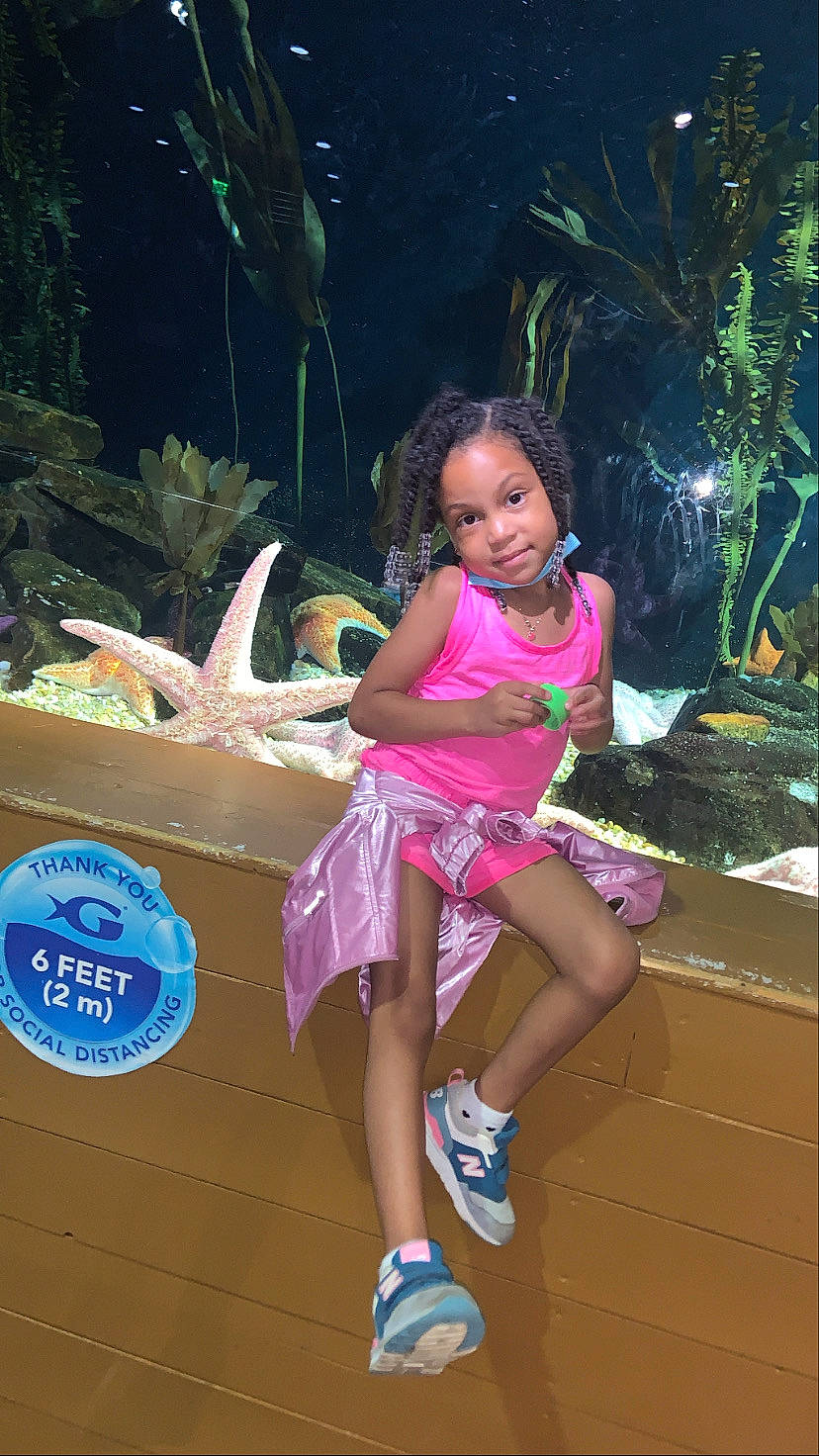 Camilla is registered to the contest to win money with this photo: beauty, child, fun, hairstyle, happy, human_leg, joy, leisure, magenta, person, pink, plant, recreation, sandal, sitting, sock, summer, thigh, toddler, vacation