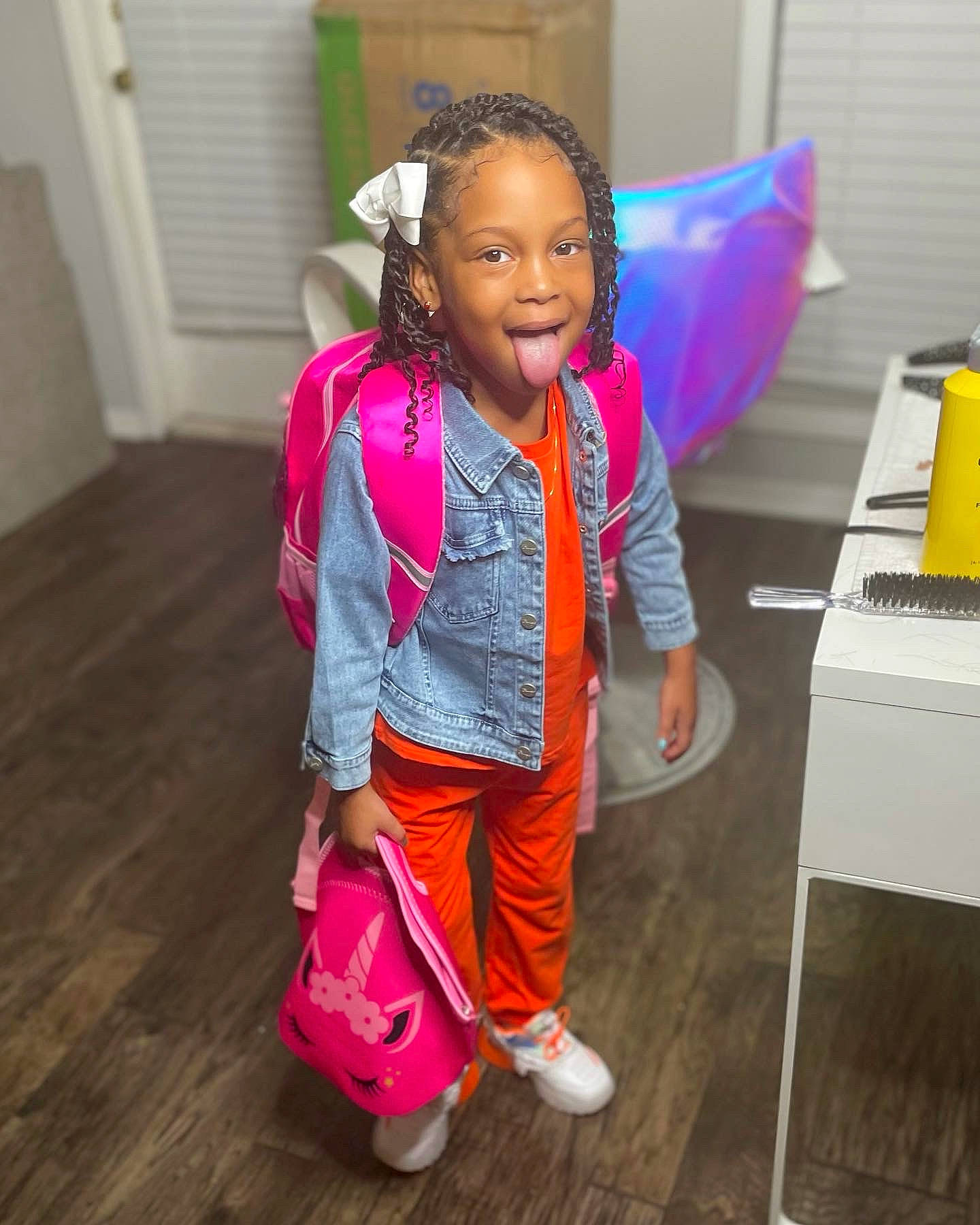 Camilla joined the competition — help win amazing prizes! bag, child, clothing, computer_keyboard, desk, event, fashion_accessory, fashion_design, flooring, fun, hairstyle, happy, jewellery, luggage_and_bags, magenta, person, pink, sandal, smile, table