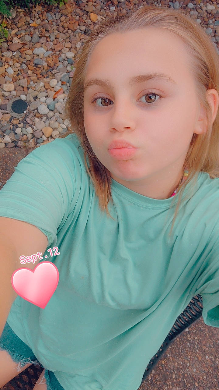 Makenzie is registered to the contest to win money with this photo: azure, beauty, eye, eyelash, grass, happy, head, human_body, leisure, lip, long_hair, mouth, neck, nose, people_in_nature, person, pink, shoulder, skin, sleeve