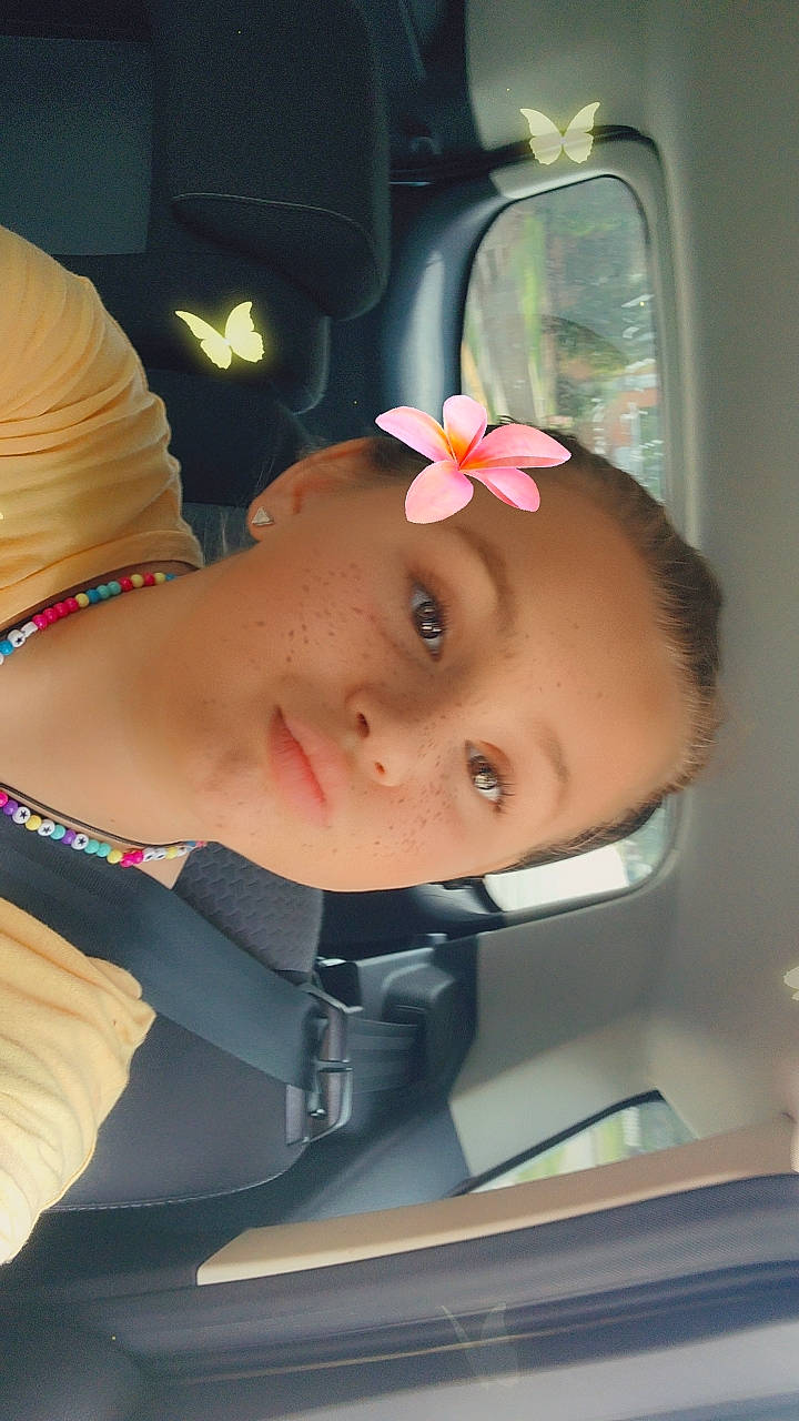 Makenzie is registered to the contest to win money with this photo: abdomen, cheek, chest, ear, elbow, eyebrow, eyelash, eyewear, fashion_accessory, flower, hairstyle, jewellery, lip, mouth, neck, nose, person, rose, skin, throat