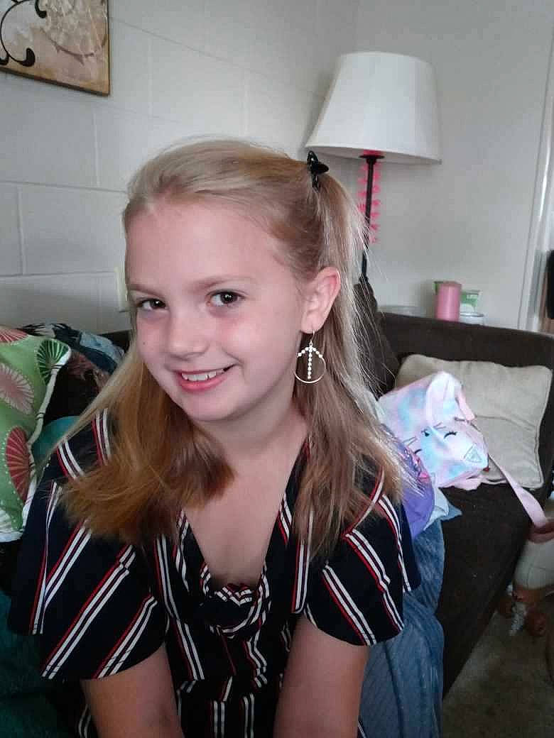 Brianna is registered to the contest to win money with this photo: blond, brown_hair, chair, cheerleading_uniform, chest, event, fashion_accessory, fun, hair_coloring, happy, jewellery, joy, lamp, long_hair, necklace, pattern, person, room, smile, sportswear