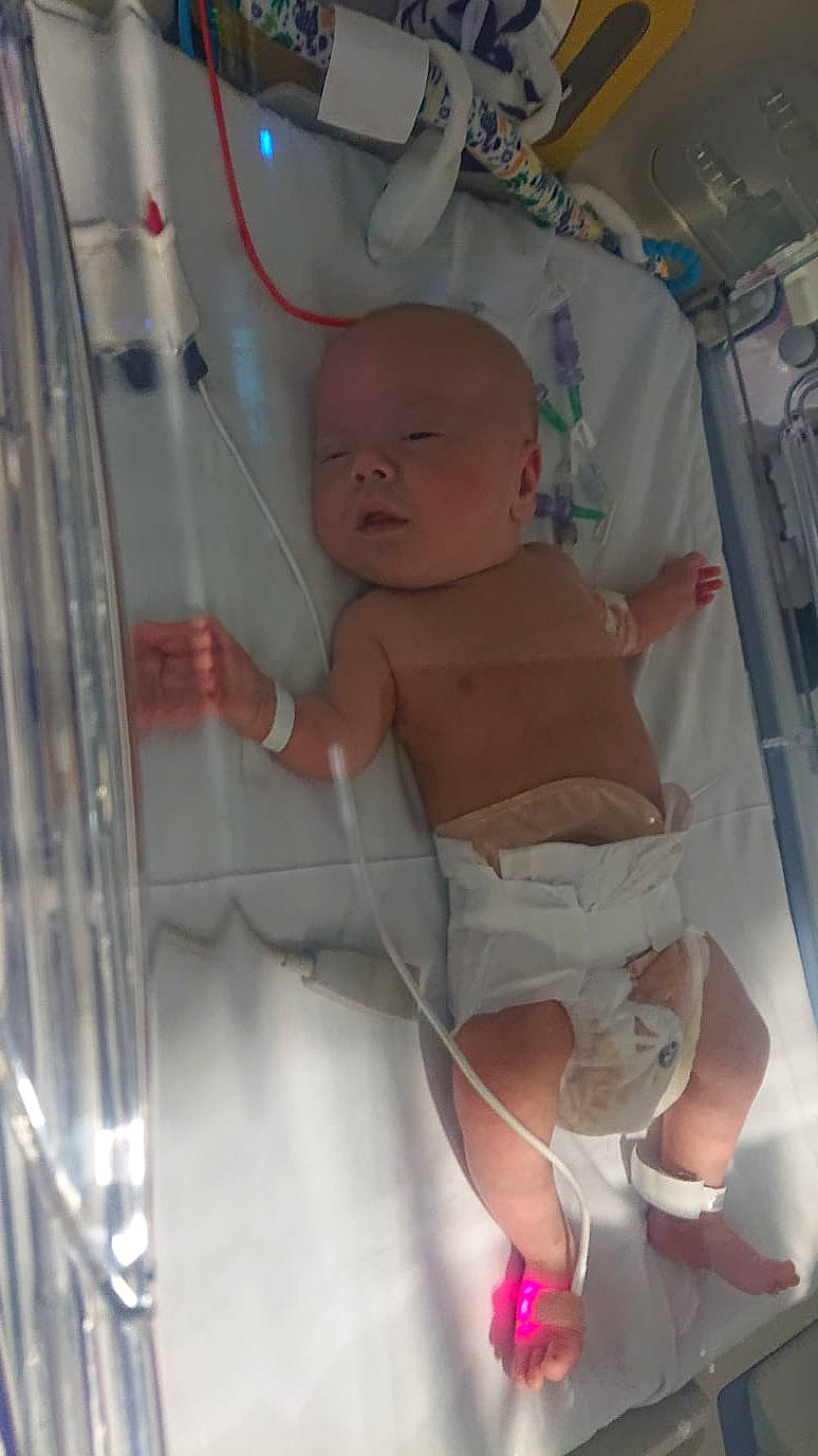 Vinnie is registered to the contest to win money with this photo: abdomen, baby, baby_products, baby_safety, baby_toddler_clothing, bathing, cheek, chest, child, comfort, diaper, fun, hood, mouth, person, product, room, skin, stomach, thumb