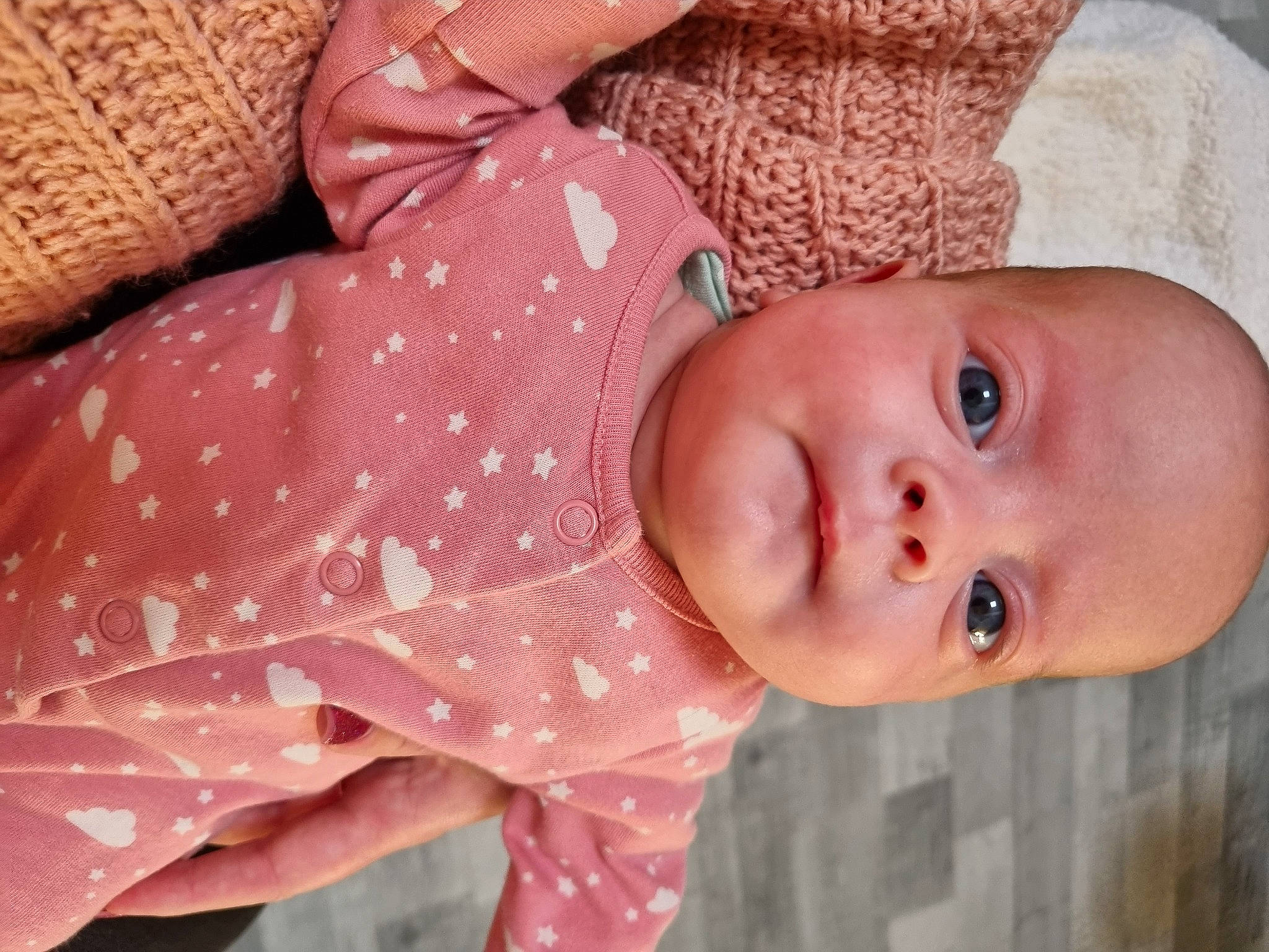 Emelie is registered to the contest to win money with this photo: baby, baby_toddler_clothing, cheek, child, chin, comfort, face, head, human_body, iris, linens, lip, mouth, nose, pattern, person, pink, skin, sleeve, textile