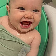 Kenley is registered to the contest to win money with this photo: baby, child, bath, water, smiling, happy, towel, skin, wet, cute, infant, splash, closeup, face, arm, indoors, blue_eyes, chubby, joy, playful