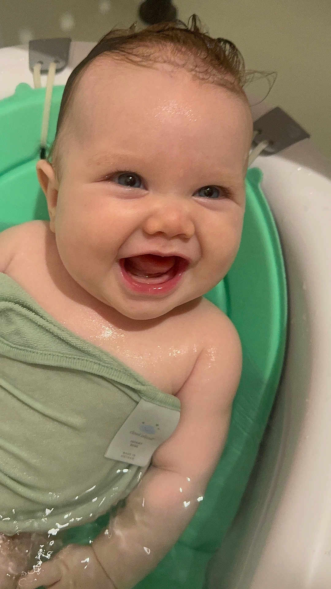 Kenley is registered to the contest to win money with this photo: baby, child, bath, water, smiling, happy, towel, skin, wet, cute, infant, splash, closeup, face, arm, indoors, blue_eyes, chubby, joy, playful
