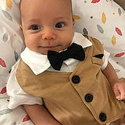 Neylann participe au concours pour gagner de l'argent avec cette photo : baby, infant, child, face, eyes, clothing, vest, bow_tie, white_shirt, blanket, pattern, leaf_pattern, cute, smile, portrait, indoors, skin, head, hand, person