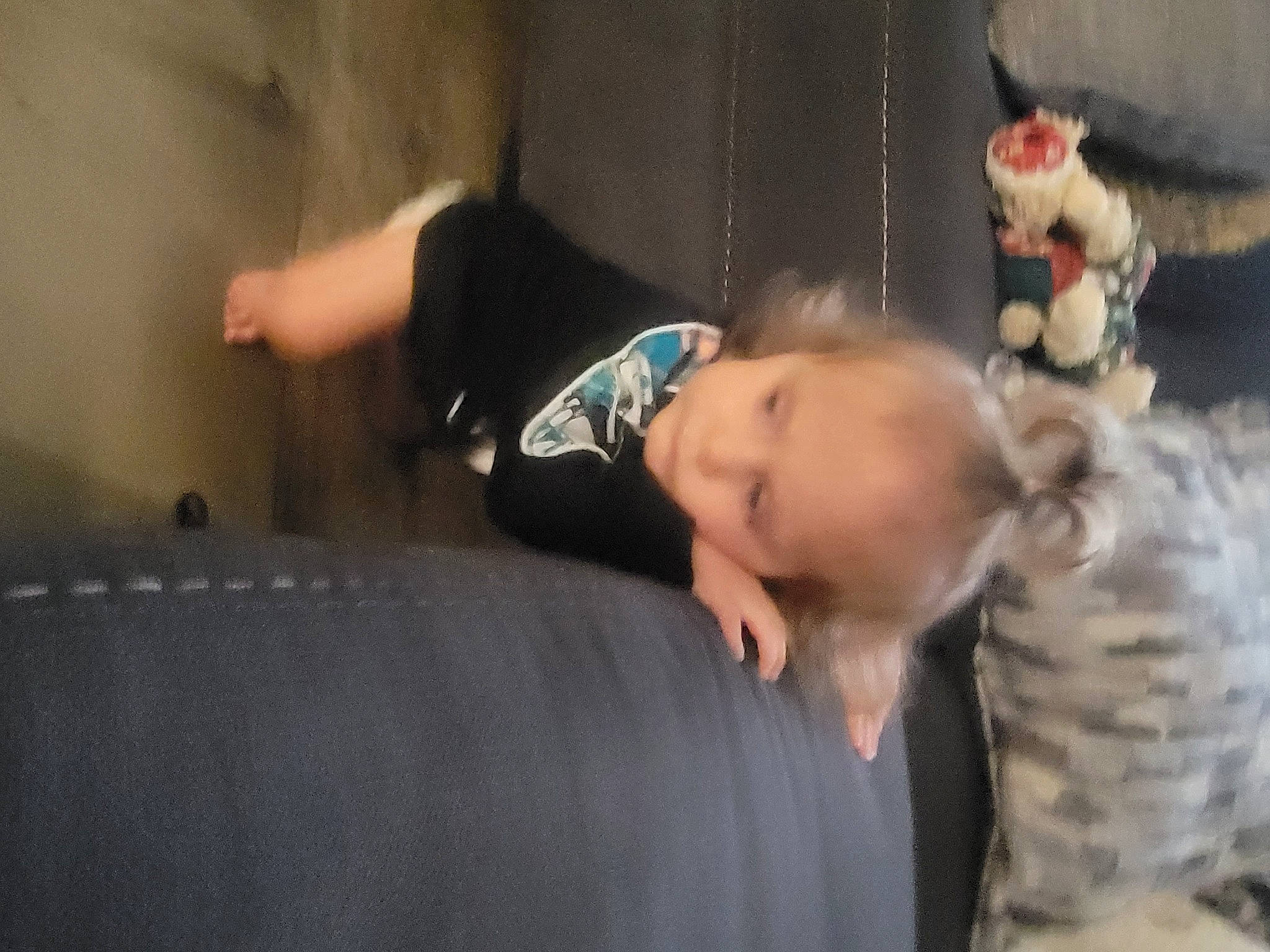 Korbyn is registered to the contest to win money with this photo: baby, baby_toddler_clothing, child, comfort, couch, event, flash_photography, fun, happy, head, human_leg, person, room, sitting, smile, stuffed_toy, suit, toddler, toy, tree
