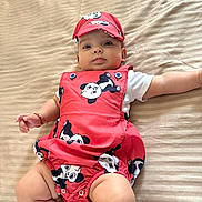 Leea participe au concours pour gagner de l'argent avec cette photo : baby, infant, panda_print, cap, red_outfit, bedspread, striped_bed, lying_down, cute, child, adorable, skin, arm, leg, clothing, face, headwear, bracelet, indoors, portrait