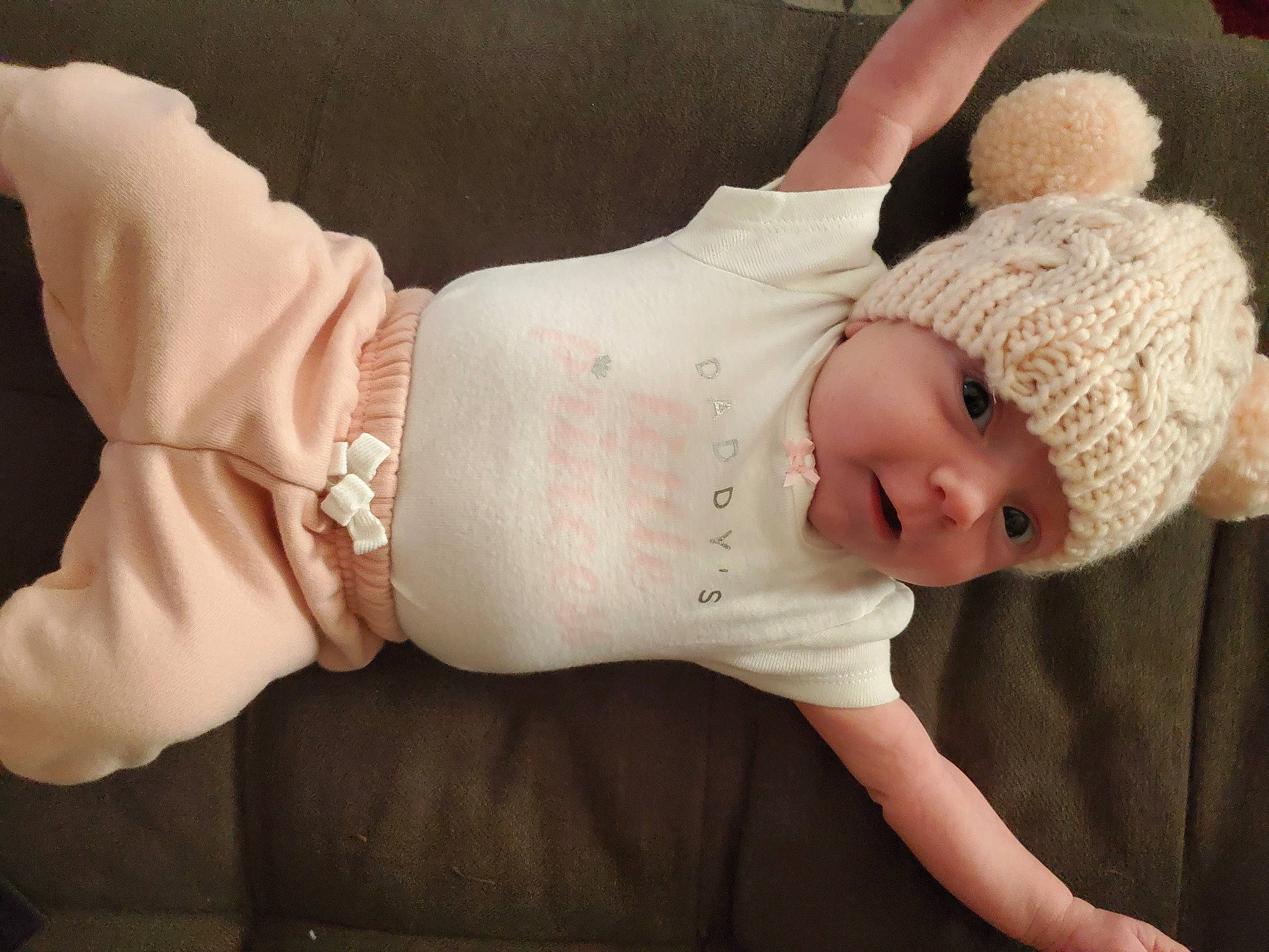 Charlotte is registered to the contest to win money with this photo: abdomen, baby, baby_sleeping, baby_toddler_clothing, cap, child, comfort, elbow, fashion_accessory, finger, hat, headwear, human_body, human_leg, knee, knit_cap, person, skin, sleeve, smile