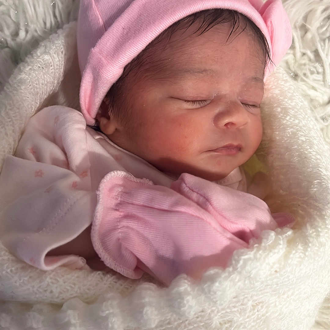 Zavi joined the competition — help win amazing prizes! baby, blanket, child, cozy, cute, face, indoors, infant, knitted, mittens, newborn, peaceful, person, pink_hat, portrait, resting, sleeping, soft, warm, wrapped