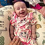 Sophia is registered to the contest to win money with this photo: baby, infant, smiling, cute, onesie, bunny, animal_print, cushion, hand, happy, child, portrait, indoors, colorful, patterned, young, toddler, clothing, resting, playful