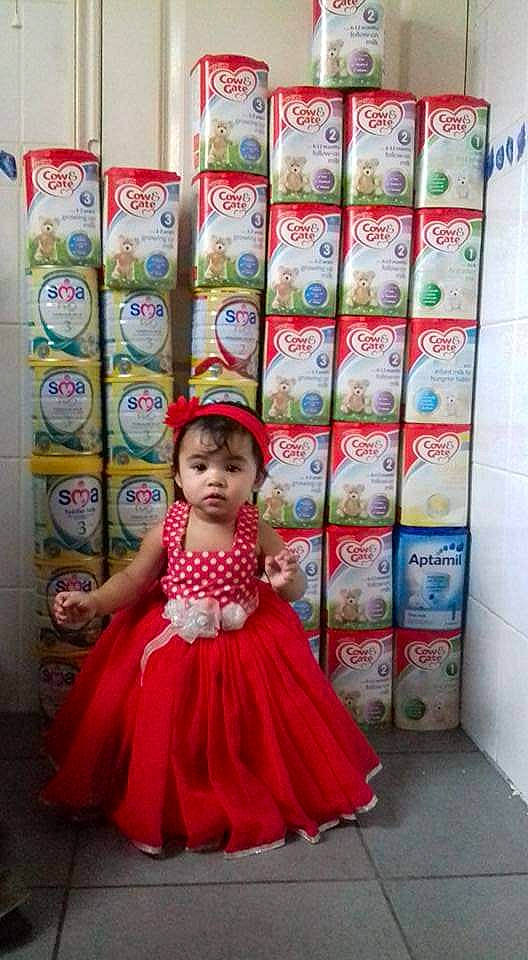 Chelsea Opingo Calsas joined the competition — help win amazing prizes! baby_toddler_clothing, child, clothing, design, embellishment, fashion_design, floor, flooring, happy, linens, magenta, pattern, person, pink, product, room, ruffle, sleeve, snapshot, textile