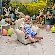 Kasen is registered to the contest to win money with this photo: baby, child, smiling, chair, easter_eggs, plush_bunnies, flowers, greenery, wood_floor, bow_tie, suspenders, indoor, decorations, cute, holiday, spring, portrait, happy, small_chair, festive