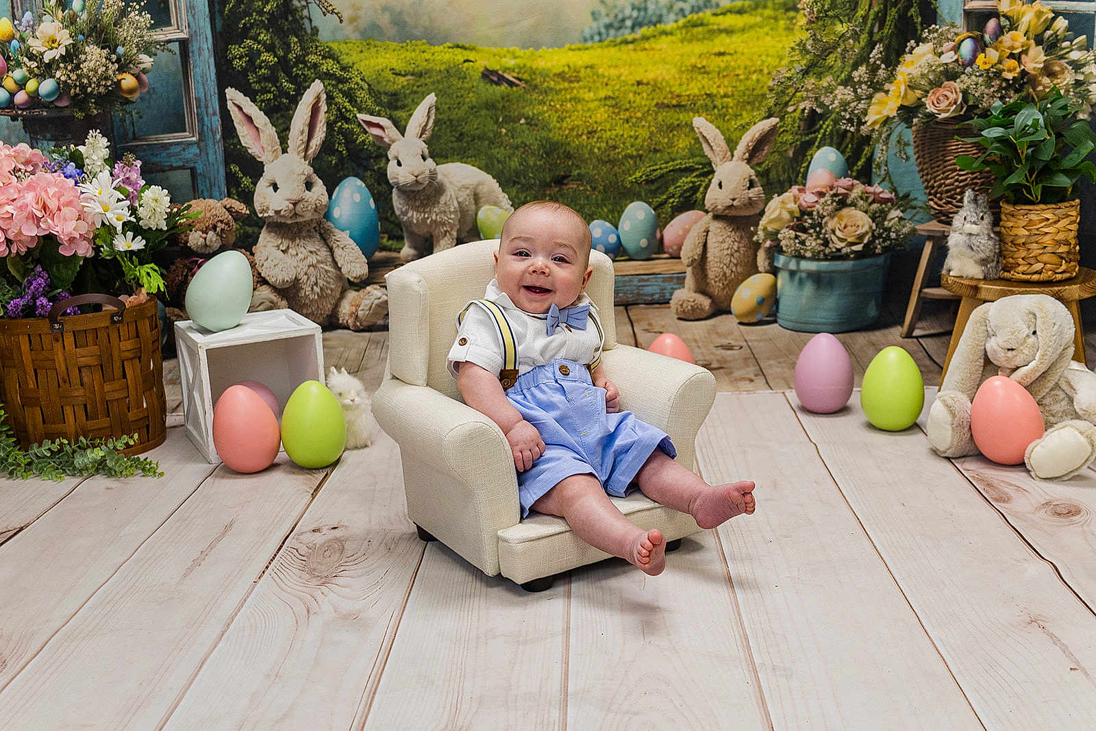 Kasen is registered to the contest to win money with this photo: baby, child, smiling, chair, easter_eggs, plush_bunnies, flowers, greenery, wood_floor, bow_tie, suspenders, indoor, decorations, cute, holiday, spring, portrait, happy, small_chair, festive